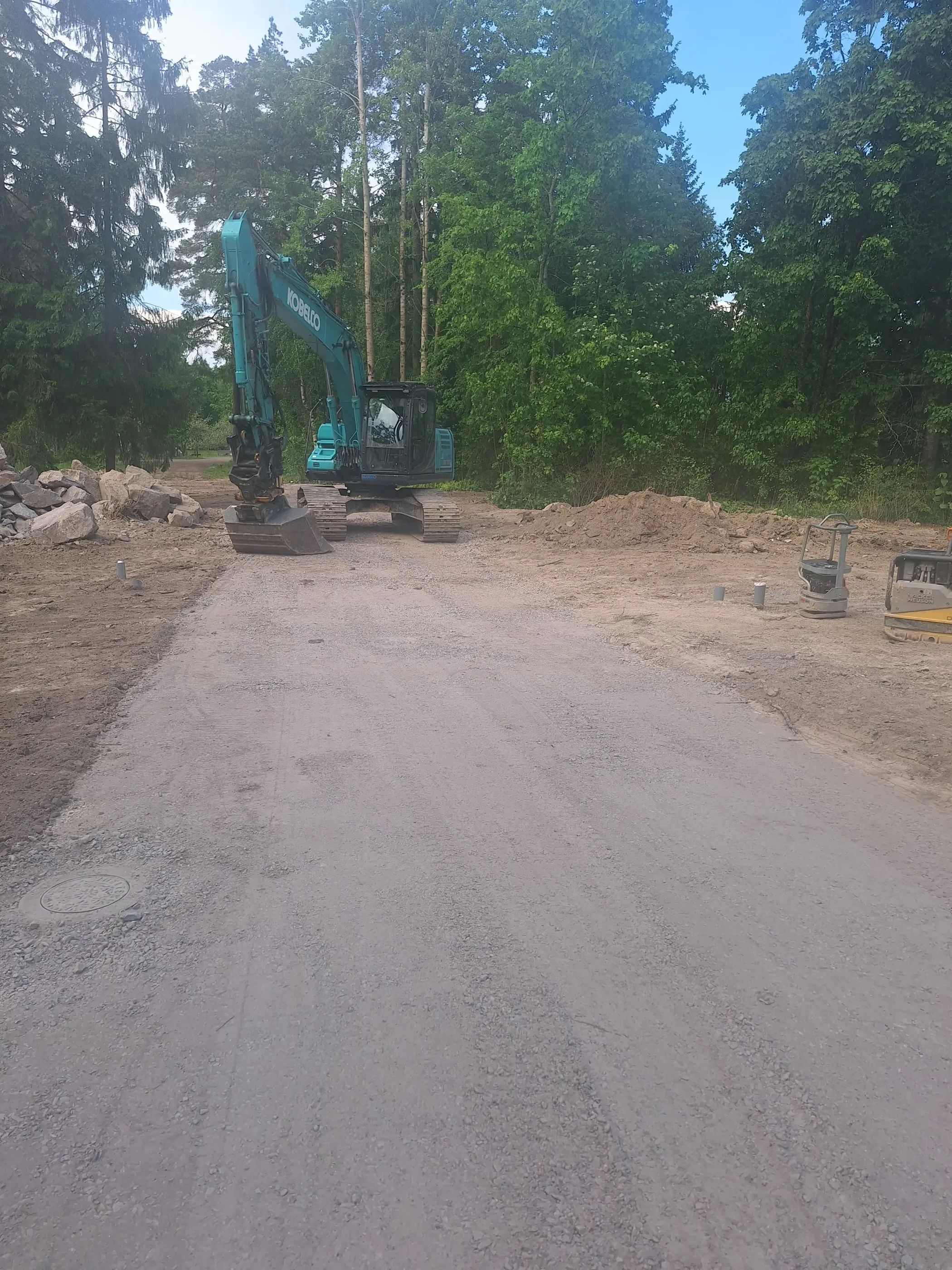 Turkoosi kaivinkone TJ Maanrakennus